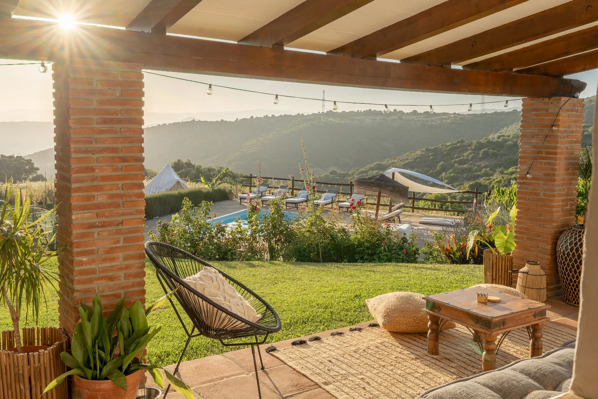 The whitewashed villa at La Fuente framed by mature trees and hollyhocks