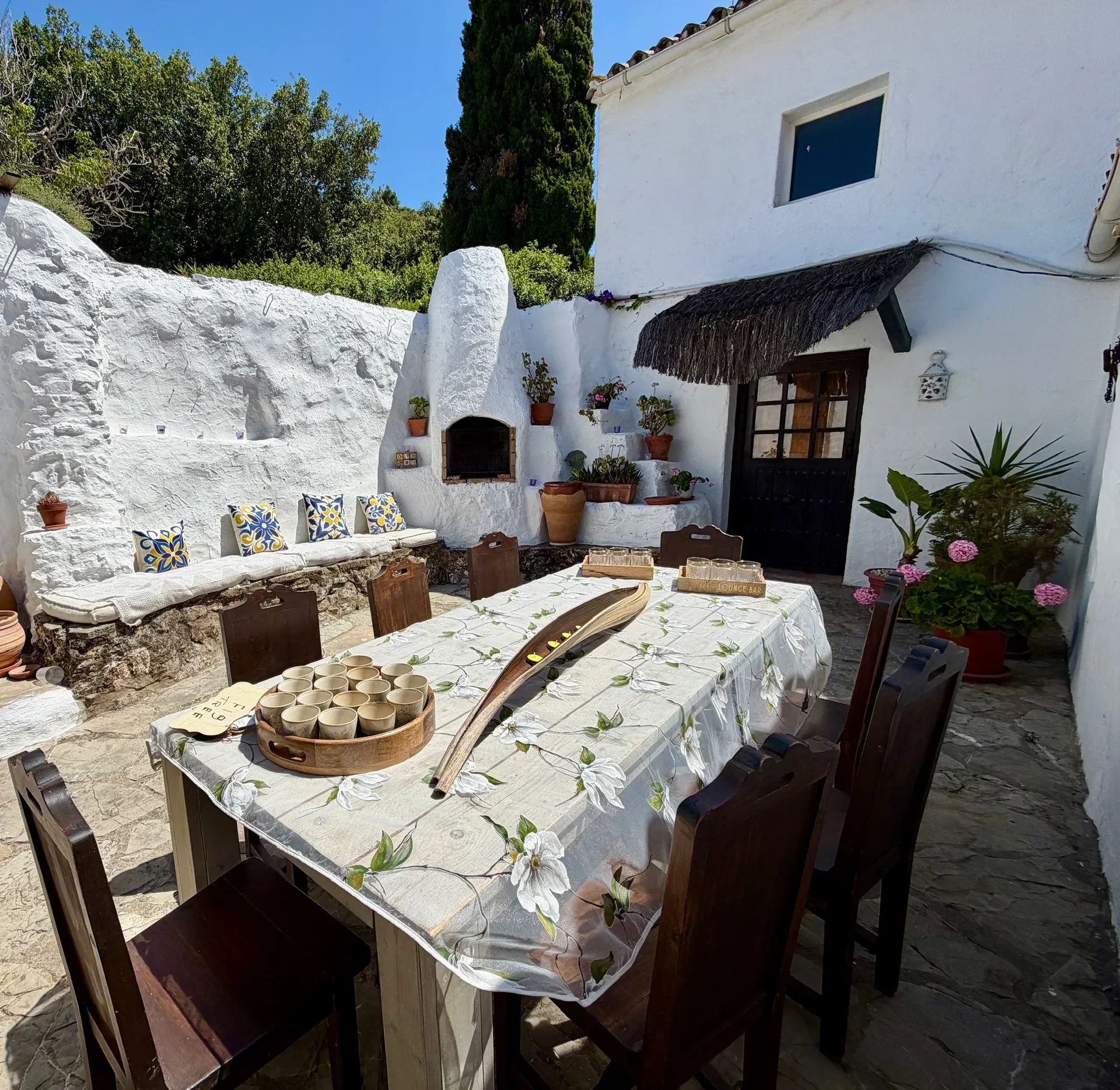 The Finca — a rustic Andalusian courtyard with a laid dining table