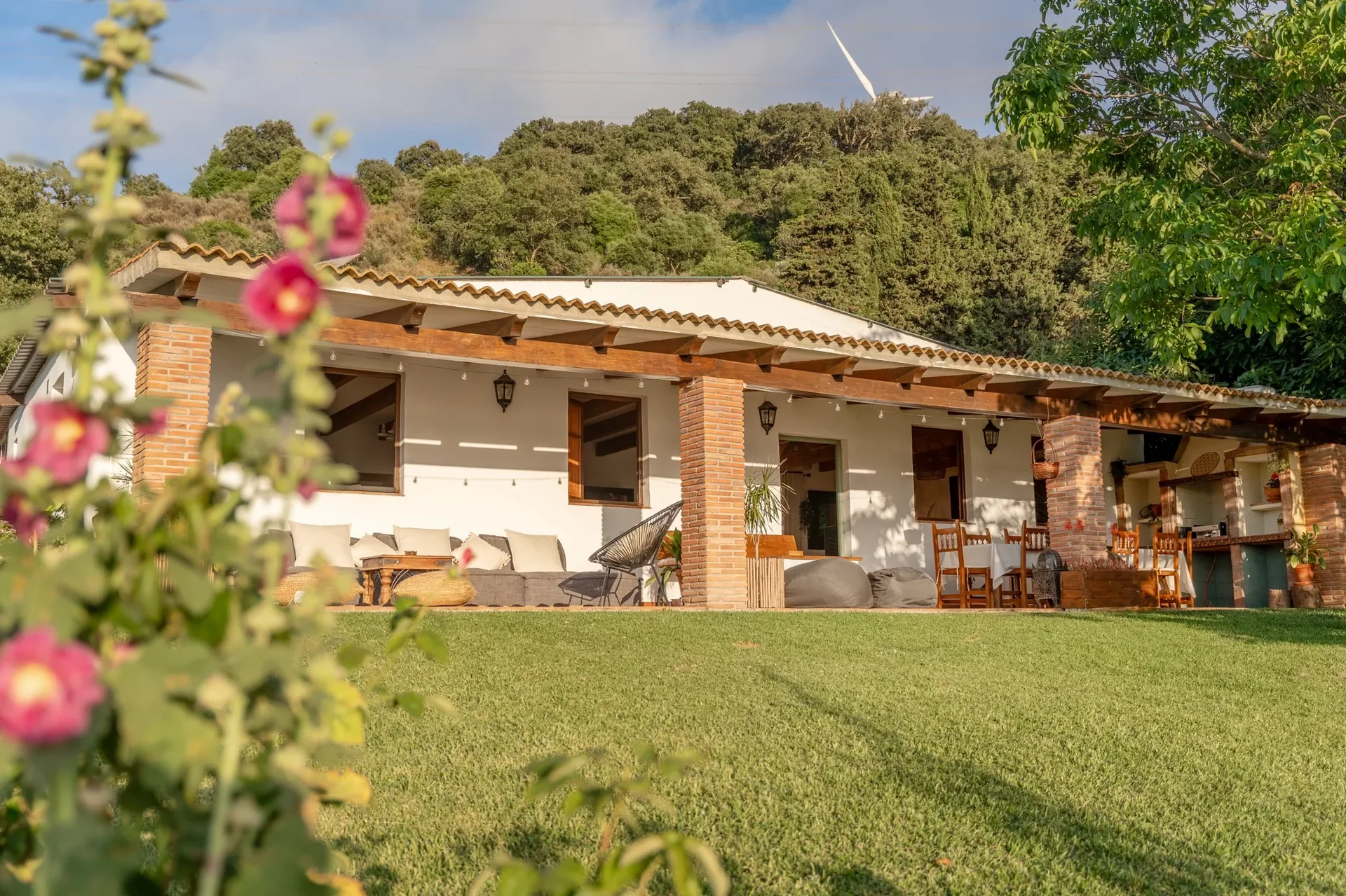 The Villa — a whitewashed Andalusian house with a shaded terrace and lawn